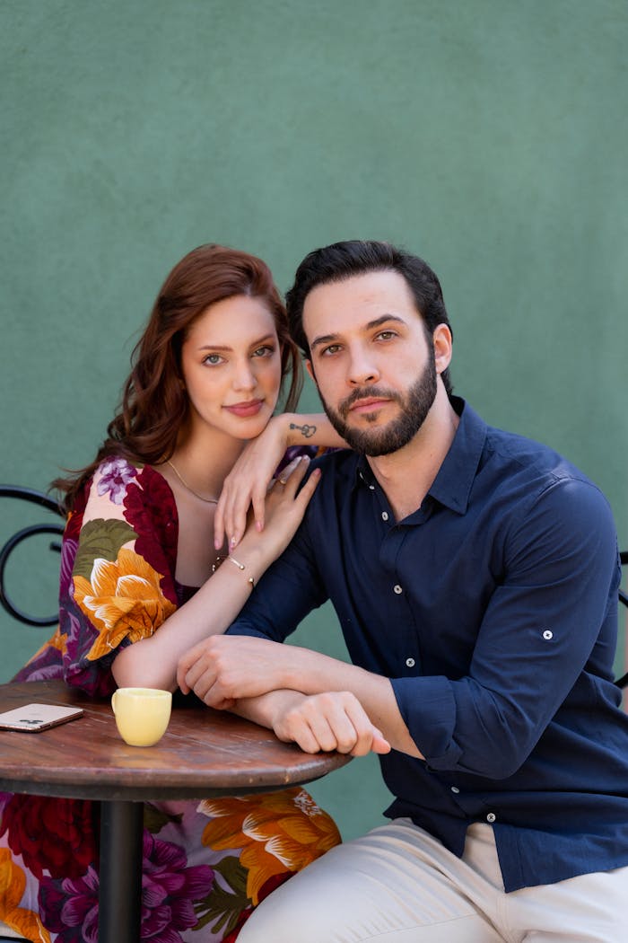 Portrait of Couple Sitting in Shirt and Dress